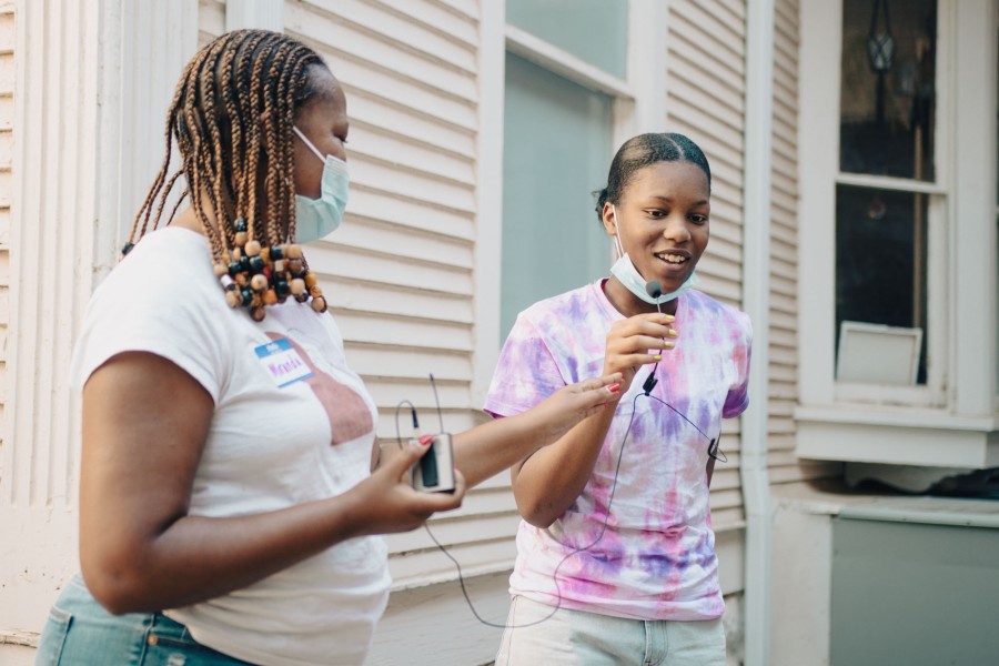 young person speaking on microphone