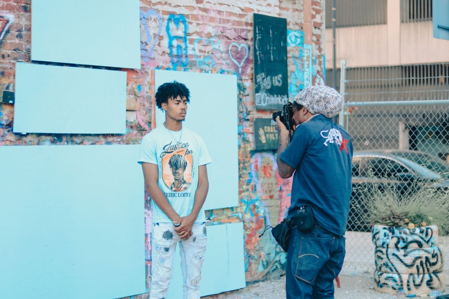 Man taking a picture of a young person.