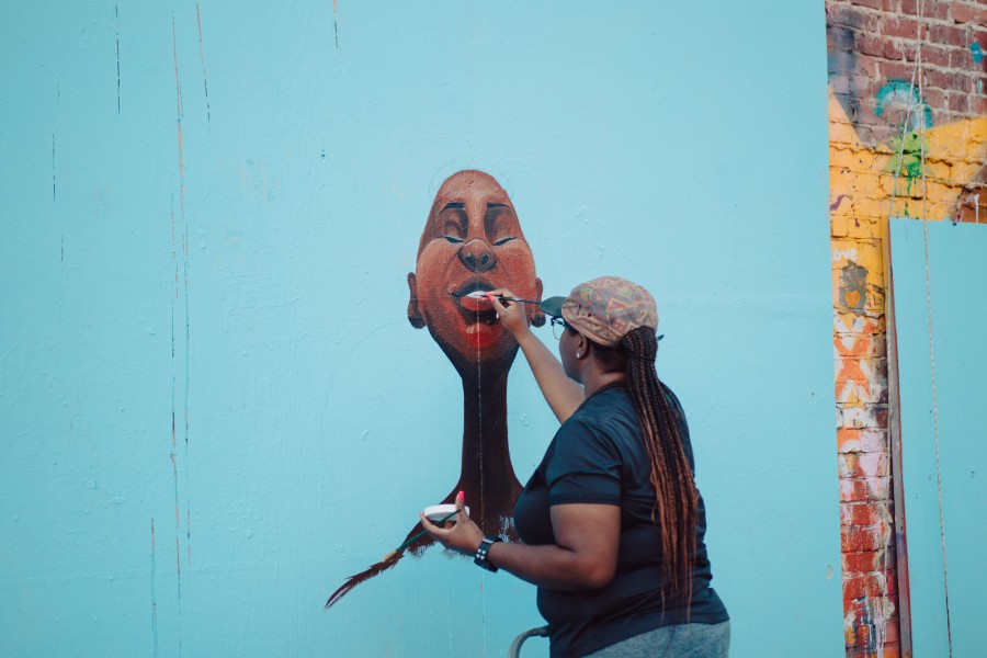 Woman painting a mural