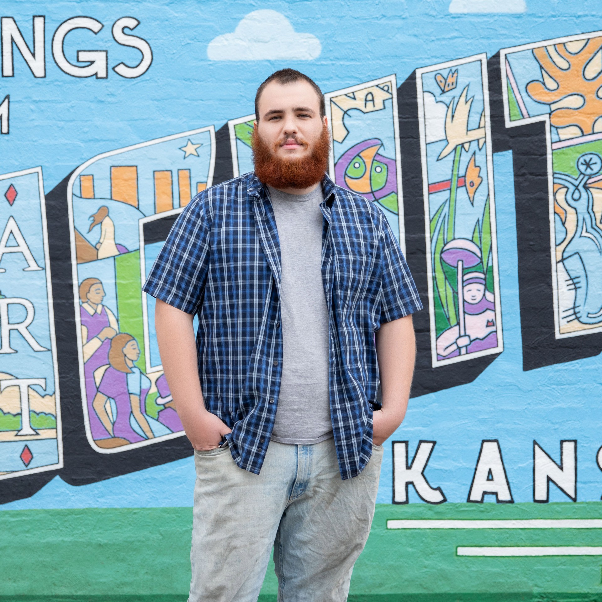 Tyler Williams portrait in front of a mural